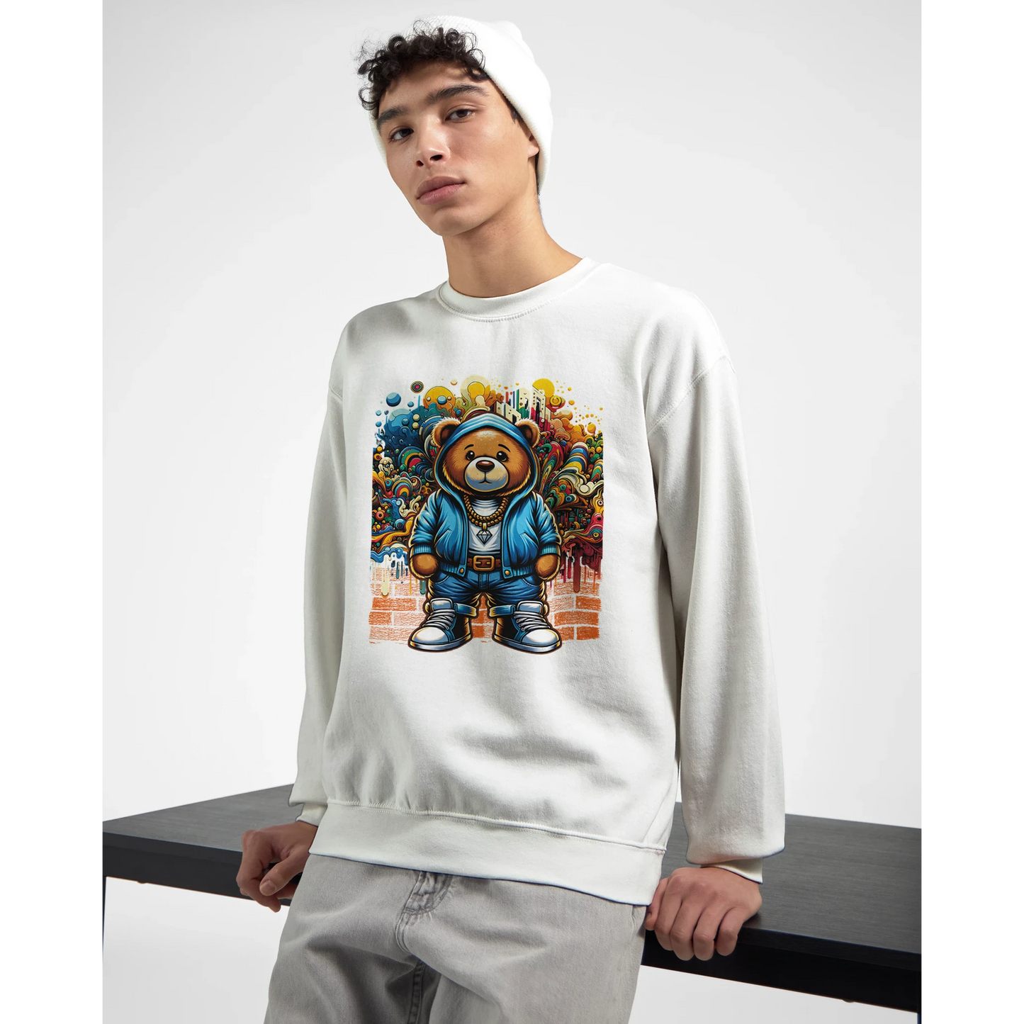Person wearing a white men's graphic sweatshirt with a colorful bear graphic design.