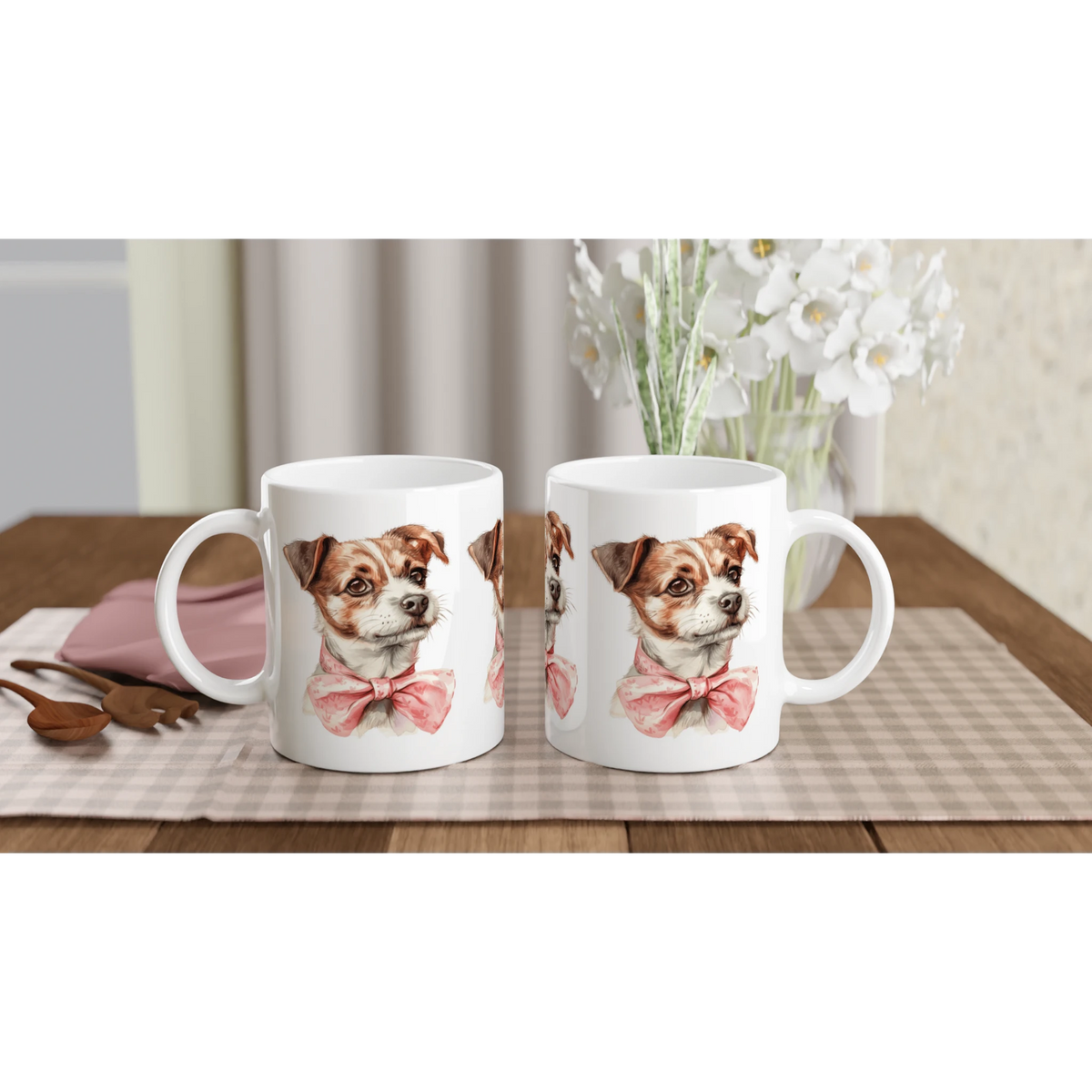 Pair of white ceramic mugs featuring a cute dog with a pink bow tie on a checkered table mat.