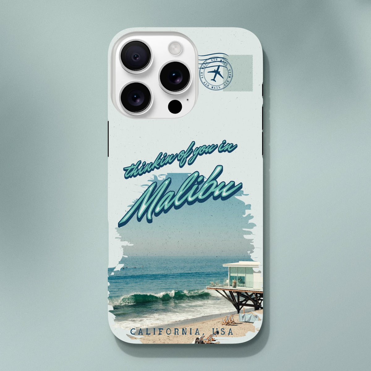 Vintage Malibu California beach iPhone case featuring "thinkin of you" script, ocean waves, pier, and air mail stamp design for tough protection.