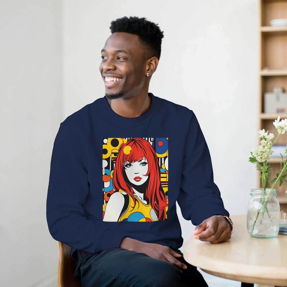 Man wearing navy blue sweatshirt featuring retro pop art graphic of a redheaded woman with colorful geometric background.