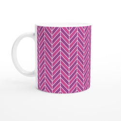 Pink ceramic mug with retro geometric herringbone pattern in purple and magenta. Smooth glazed coffee cup for modern interiors.
