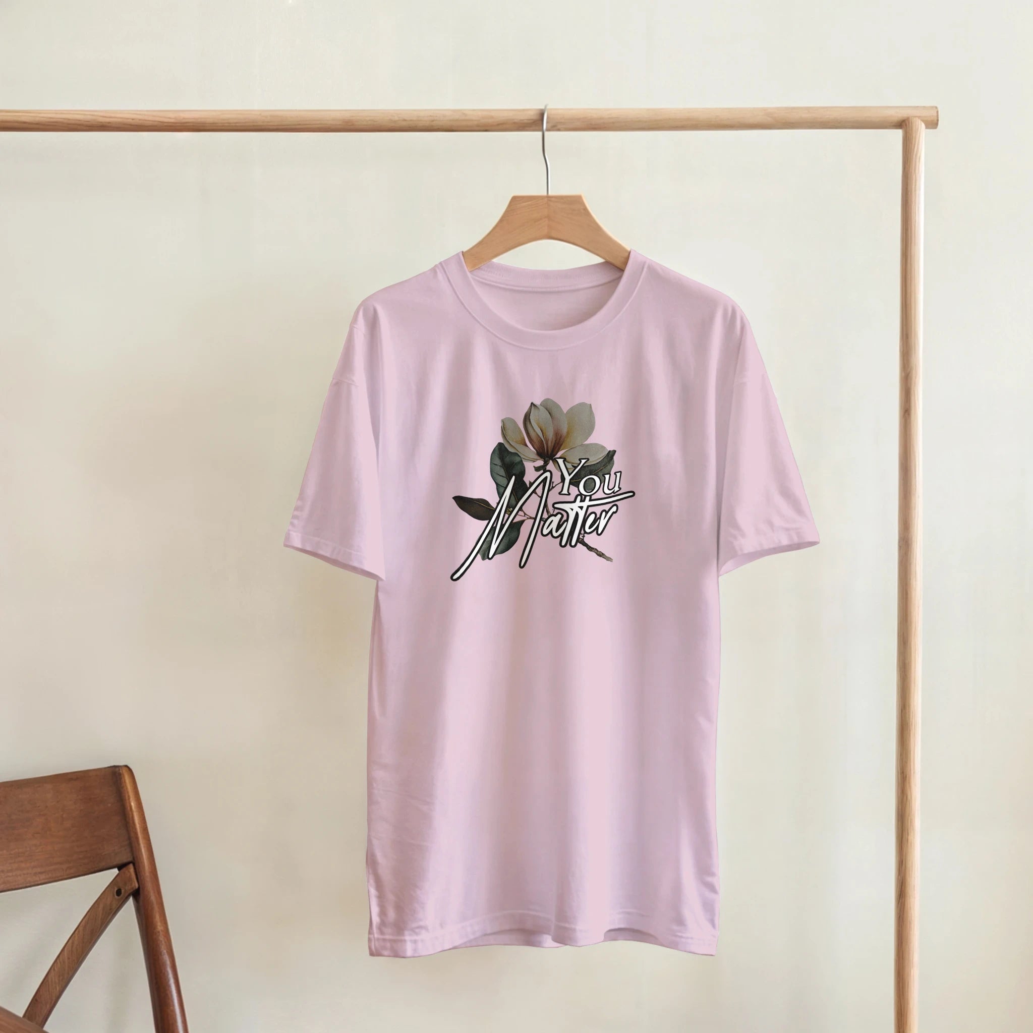 Pink women's You Matter slogan graphic tee with floral accent, soft cotton blend, relaxed fit on hanger.
