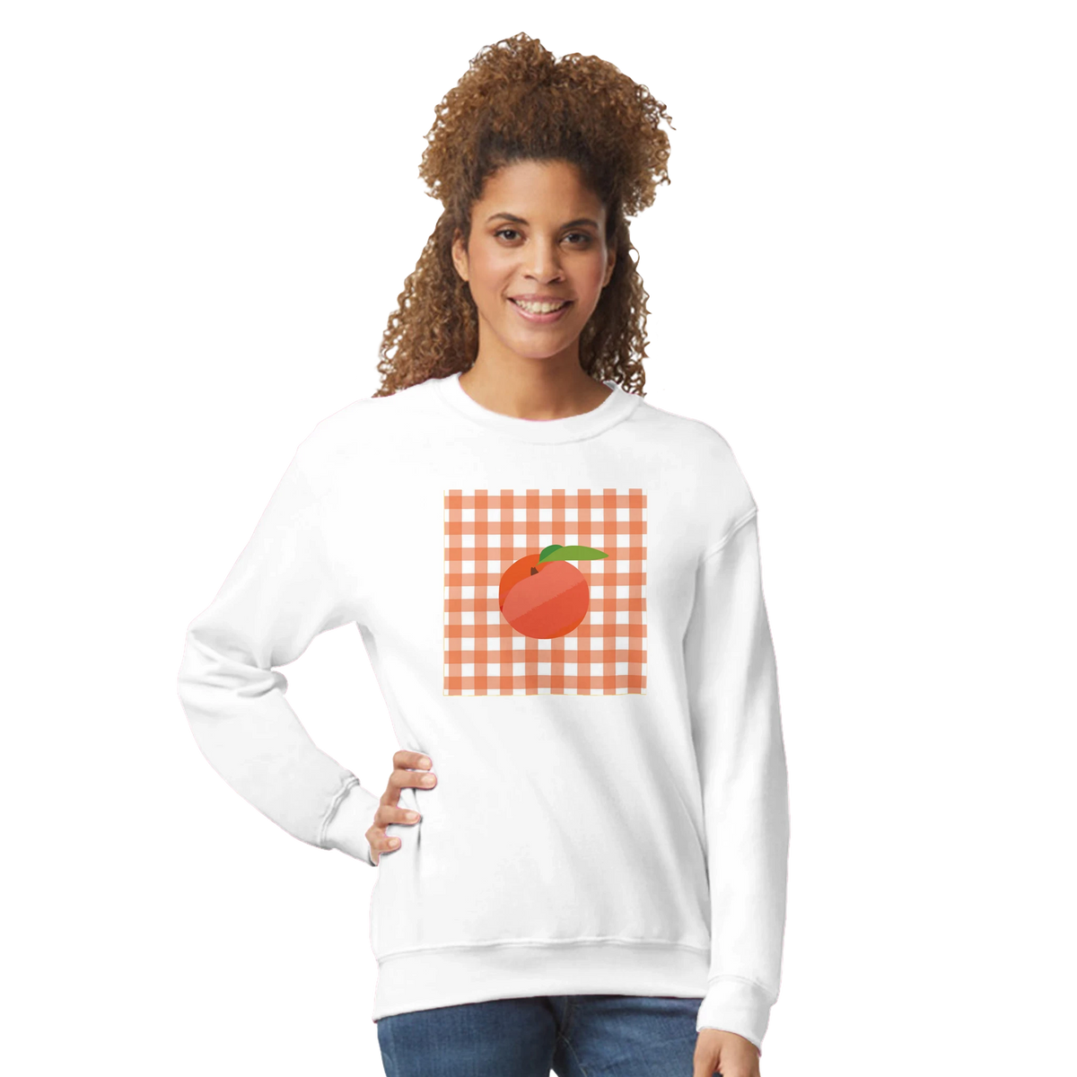 White sweatshirt featuring a retro orange gingham square graphic with a playful fruit illustration on the front.