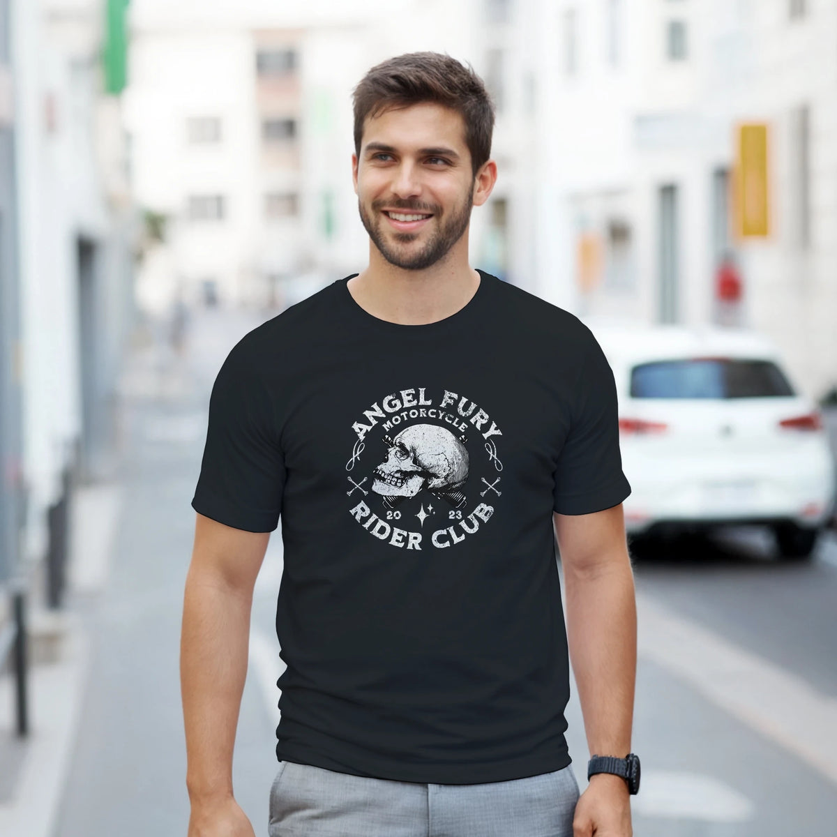 Man wearing black Angel Fury Rider Club biker skull tee with bold underground graphics for city street style.