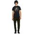 Man in black Cat DJ graphic T-shirt with colorful splash design.