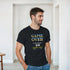 Man wearing black retro gamer T-shirt with pixelated GAME OVER text and coin insert design.