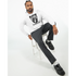 Man wearing Trance Gorilla men's graphic hoodie in white with gorilla design, dark pants, and black loafers.