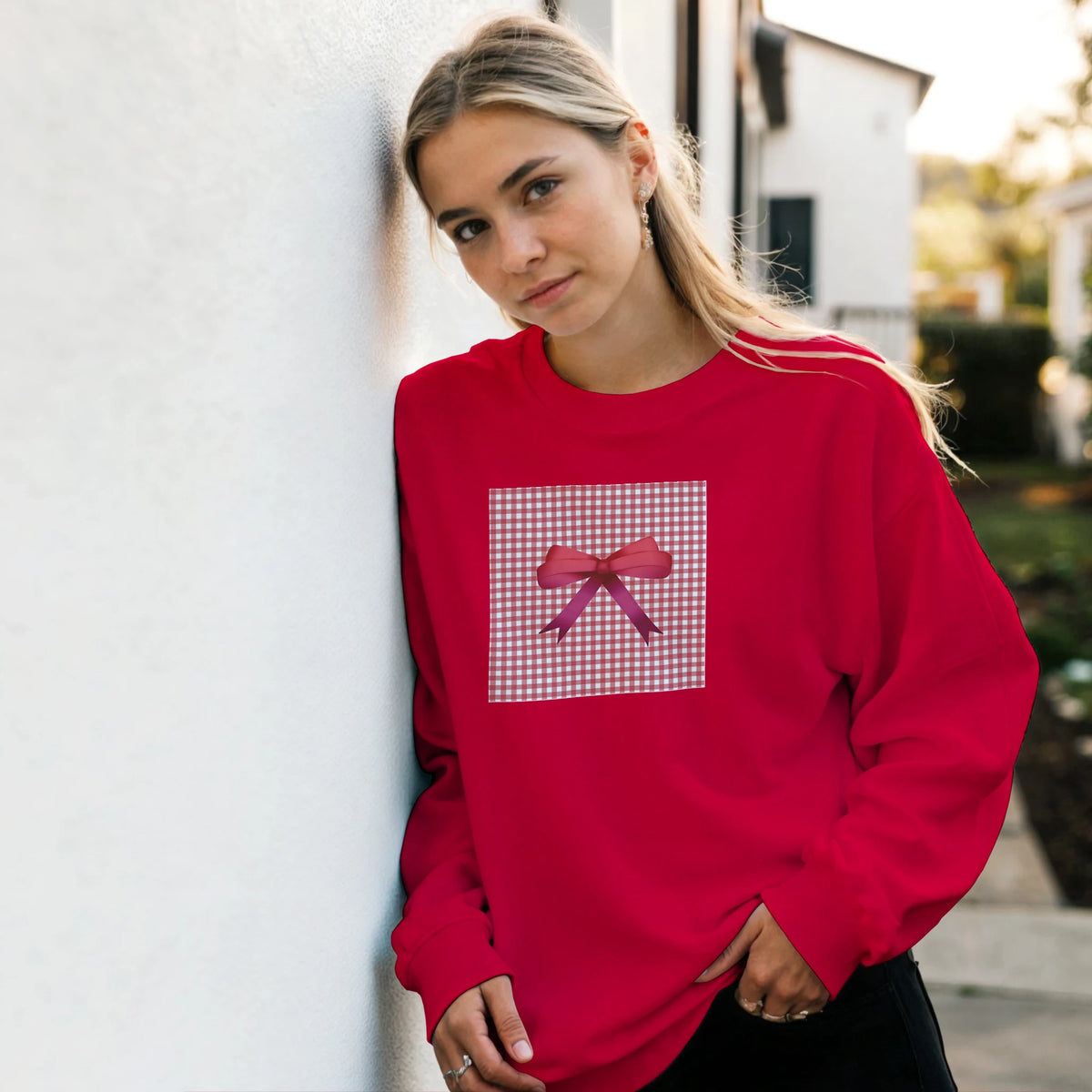 Red coquette sweatshirt featuring a pink gingham square and bow graphic on the chest.