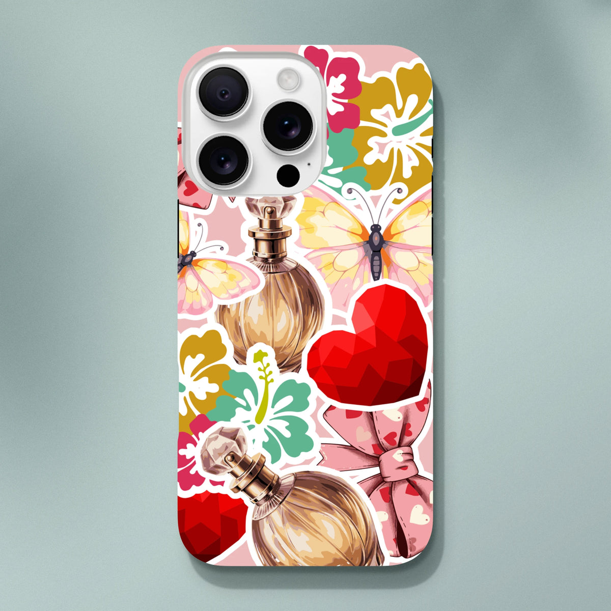 Pink floral iPhone case with sticker effect perfume bottles, butterflies, and red heart graphics. Tough full-wrap cover for streetwear style.
