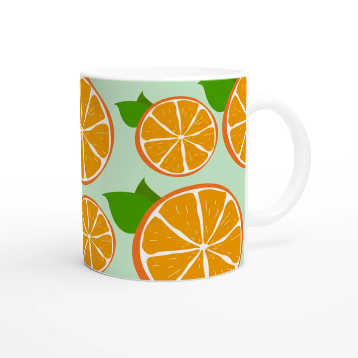 Cute orange citrus mug with orange slice pattern on mint-green background and white handle.