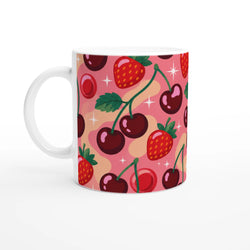 Retro pink ceramic mug featuring a cute pattern of strawberries, dark cherries, and white sparkles for coffee or tea.