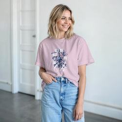 Woman wearing pink cotton-blend T-shirt with It's OK Not To Be OK slogan graphic, paired with light-wash jeans.