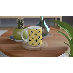 Cute yellow ceramic mug with a bee pattern, perfect for coffee or tea—great for bee lovers.
