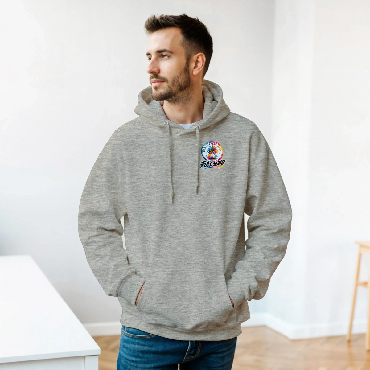 Man wearing grey static slammed car hoodie with small colorful palm tree chest graphic, featuring a front pouch pocket for petrolhead streetwear style.
