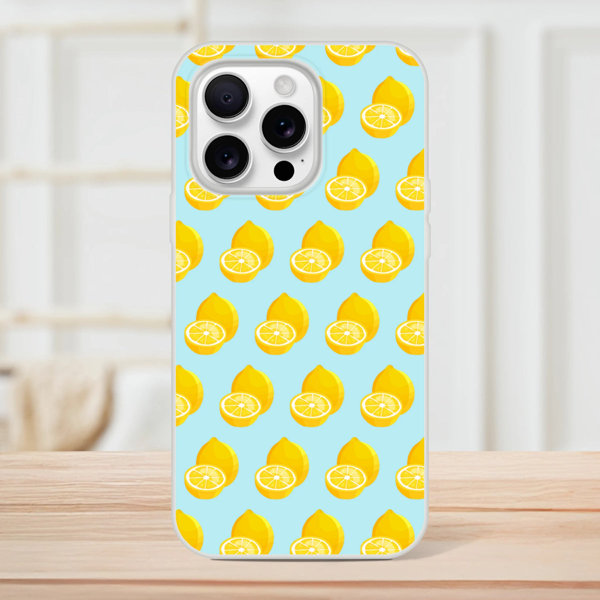 Pastel blue iPhone case featuring a yellow lemon pattern, made of flexible shock-absorbing TPU for summer fruit style protection.