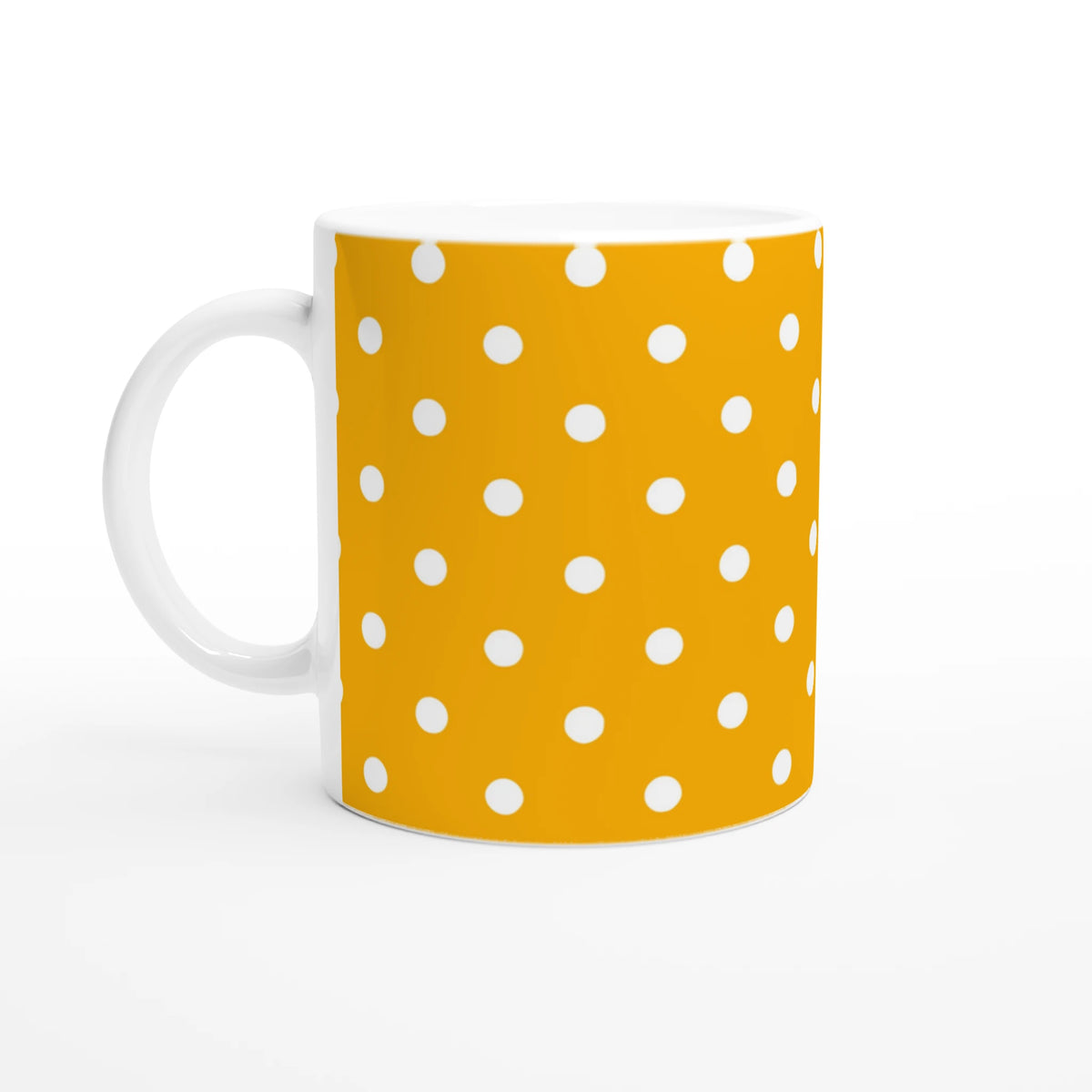 Orange and white polka dot ceramic mug with a white handle, designed for coffee or tea.