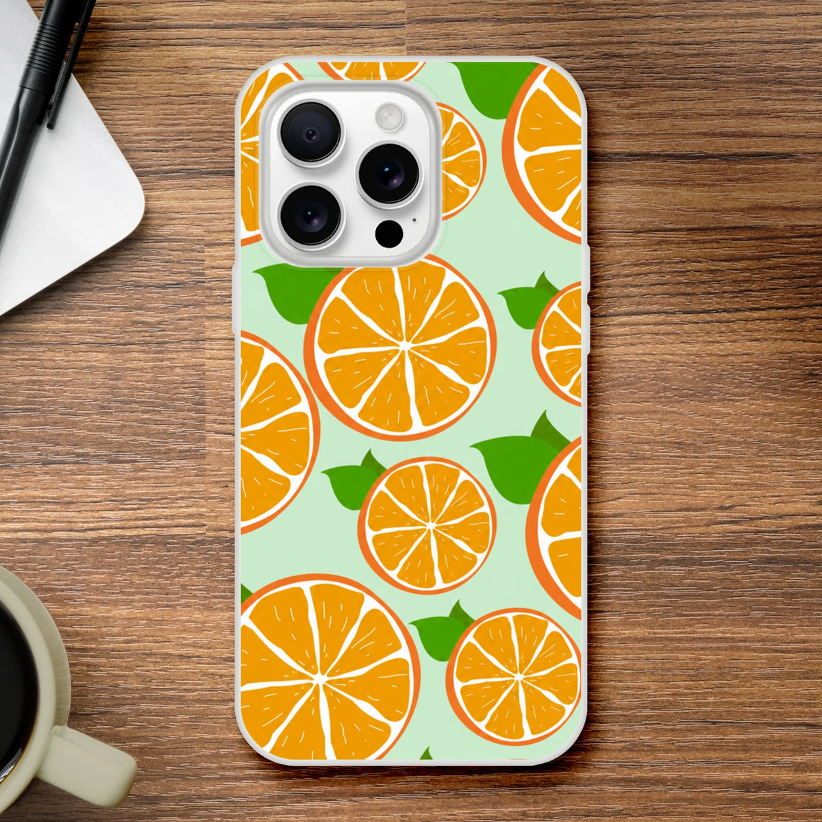 Orange citrus-pattern iPhone case on mint backdrop with frosted matte finish and slim design.