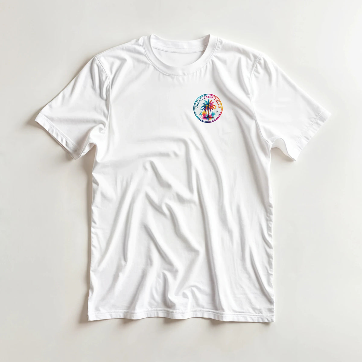 White crew neck t-shirt featuring a colorful retro Urban Palm Trees circular graphic print on the left chest.