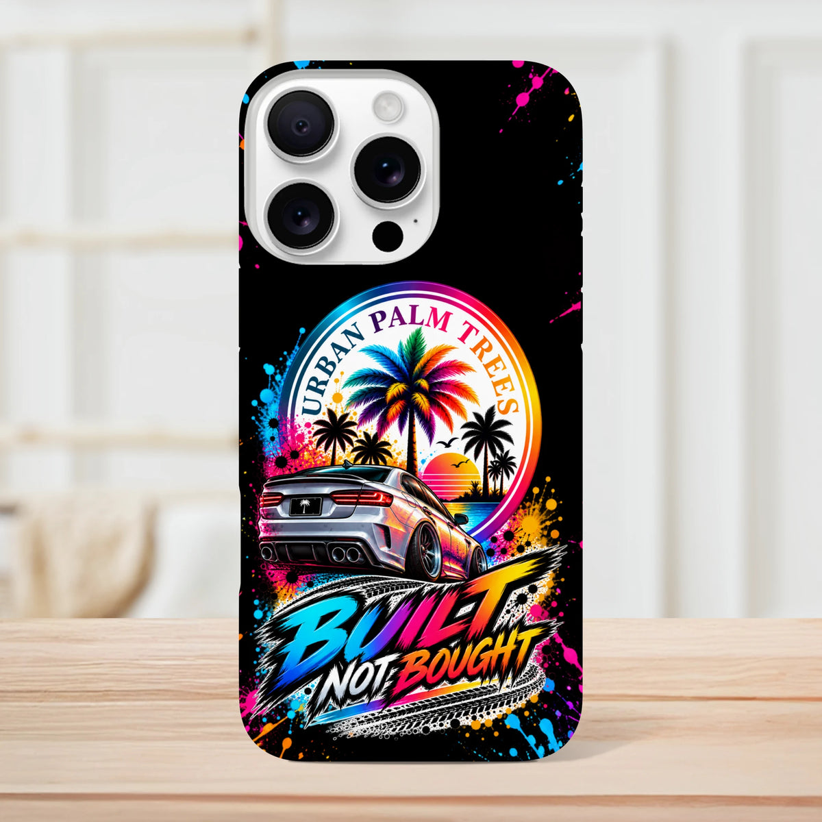 Built Not Bought iPhone case featuring a modified car, colorful Urban Palm Trees sunset graphic, and protective tough design for petrolheads.