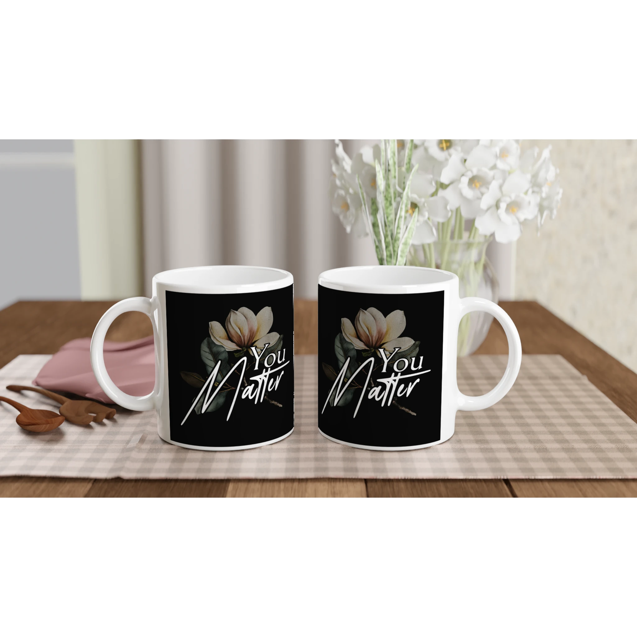 Two white mugs with black labels featuring 'You Matter' and magnolia artwork, mental health gift set.