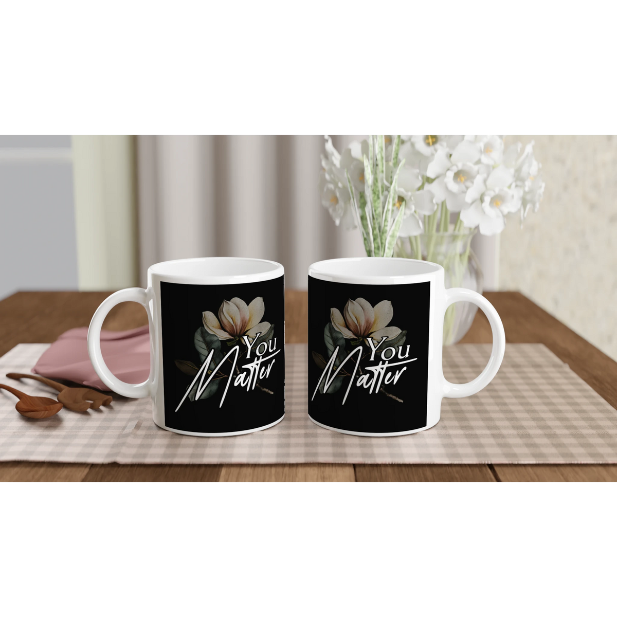 Two white mugs with black labels featuring 'You Matter' and magnolia artwork, mental health gift set.