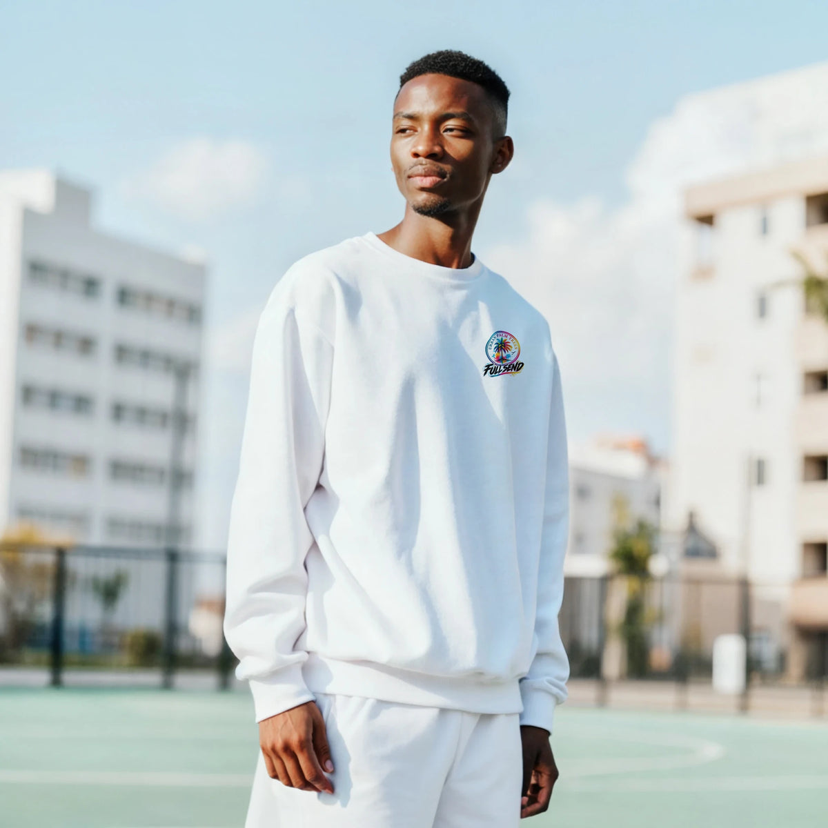 Man wearing white Fitment Petrolhead sweatshirt with small colorful chest logo. Modified car culture top for casual wear and meetups.