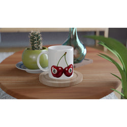 Lucky Cherries mug: white ceramic with a print of two red cherries on a wooden coaster, ideal gift for her.