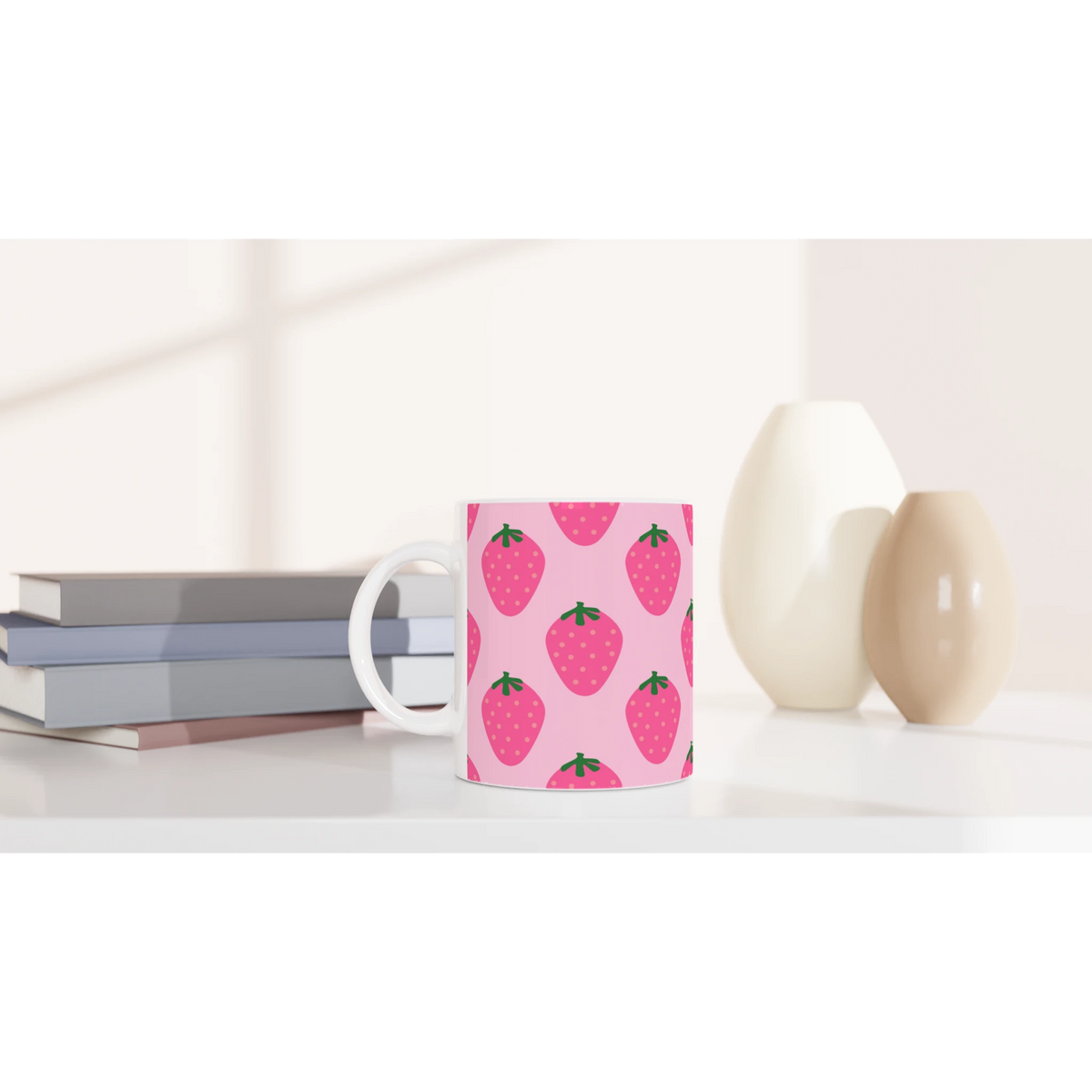 Cute pink strawberry mug with kawaii fruit design on a white desk