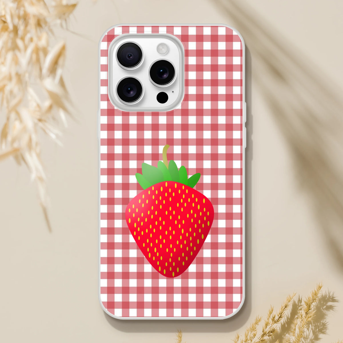 Pink strawberry-gingham iPhone case (13–16), slim matte cover with a large strawberry graphic.