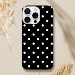 Black and white polka dot tough iPhone case with shock-absorbing TPU core and durable dual-layer frame for impact resistance.