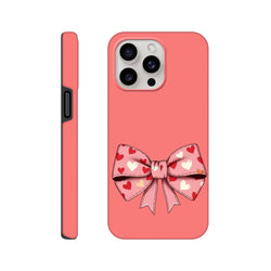 Pink iPhone case featuring a large bow with red, white, and yellow hearts on a coral background. Cute coquette tough phone cover.