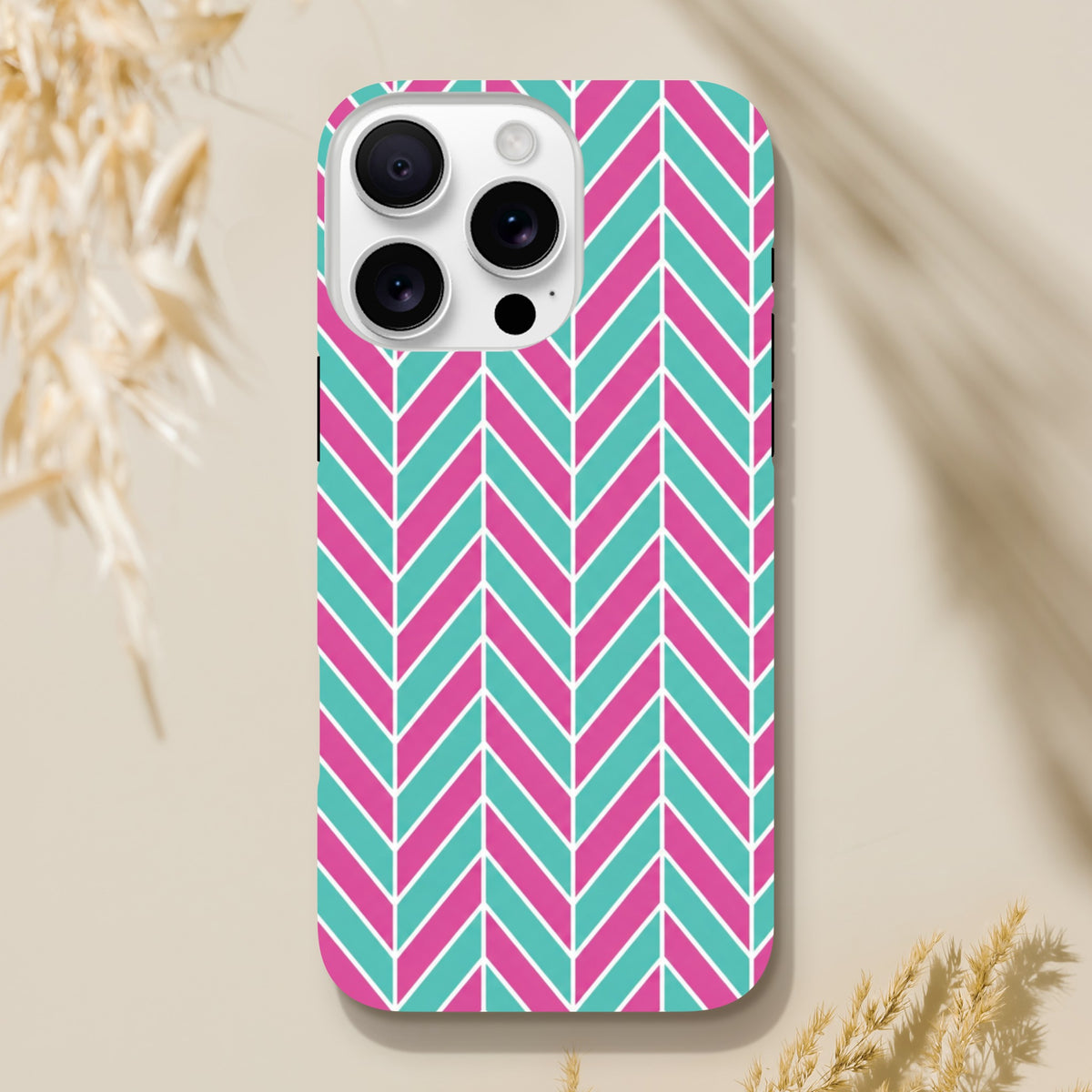 Pink and turquoise herringbone iPhone case with geometric chevron design. Tough dual-layer TPU protective cover for iPhones 13-16.
