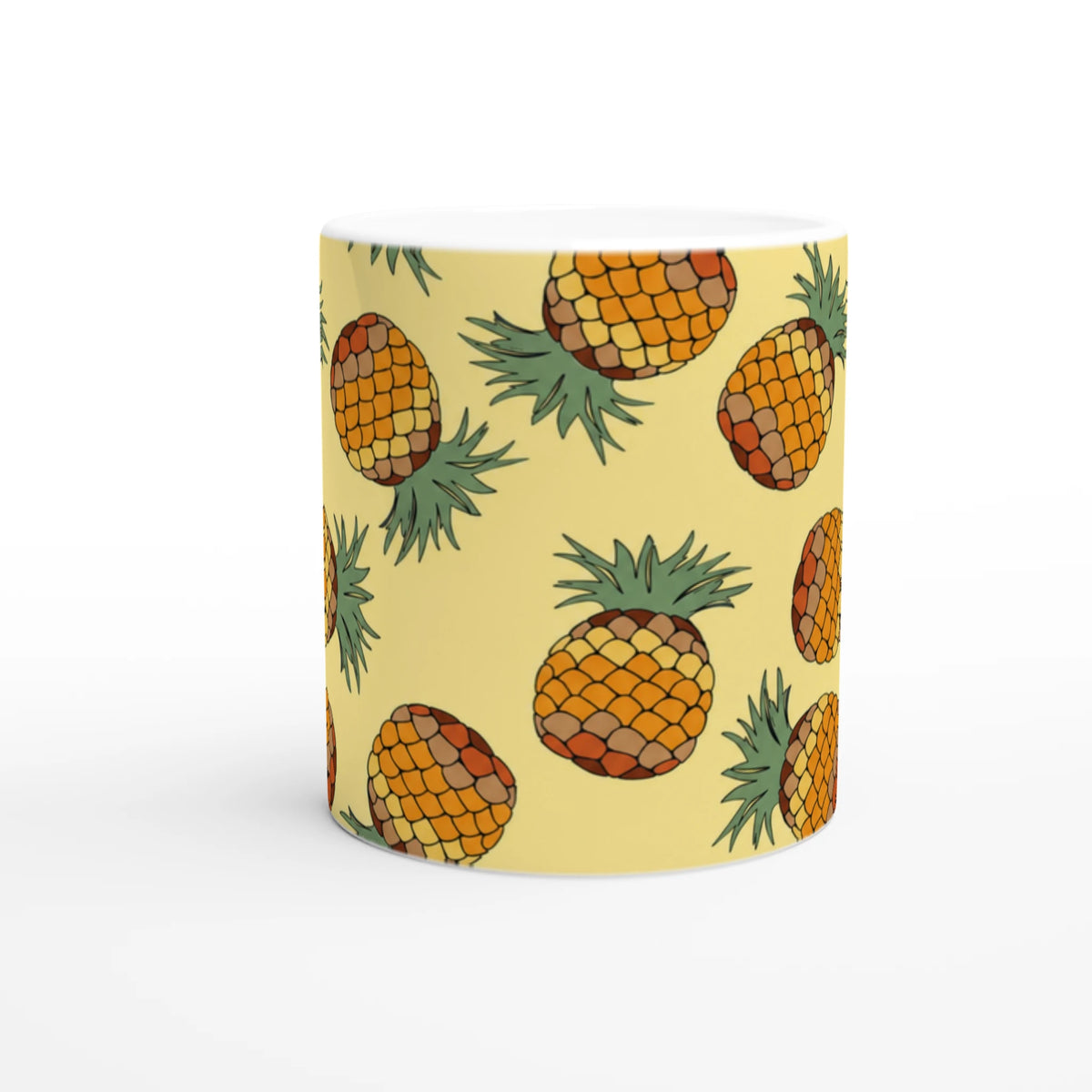 Yellow coffee mug with a playful pineapple pattern and green leaves.