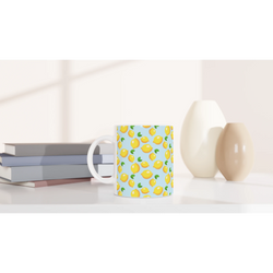 Blue lemon-pattern ceramic mug on a shelf; a cute mini citrus coffee cup.