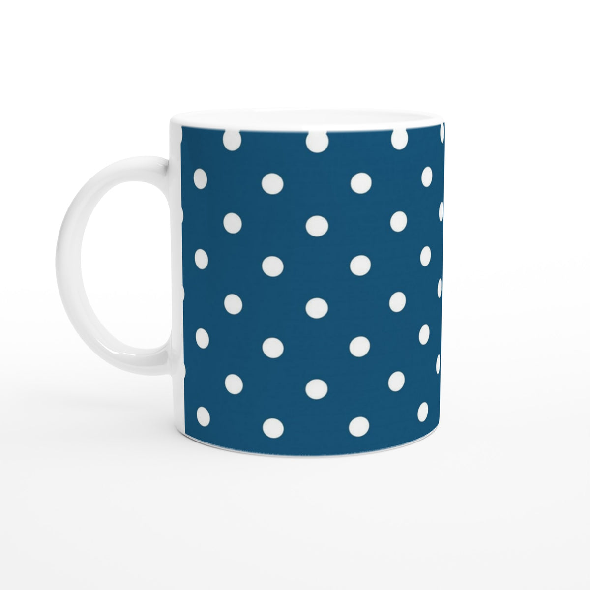 Retro navy blue ceramic mug featuring a bold white polka dot pattern. Vintage spotty coffee cup design for daily use.