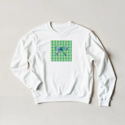 White sweatshirt featuring a green gingham square graphic with a purple bow, showcasing a cute coquette aesthetic pullover design.
