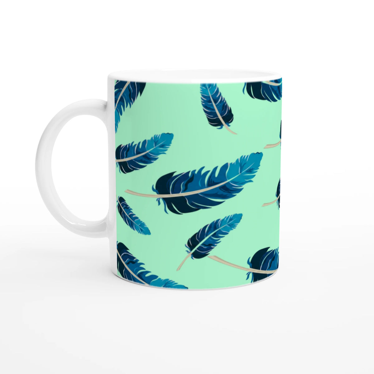 Blue Feather Mug with mint-green gradient and blue feather pattern, white handle.