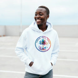 Smiling person wearing a white Urban Palm Trees hoodie with a retro streetwear palm tree graphic.