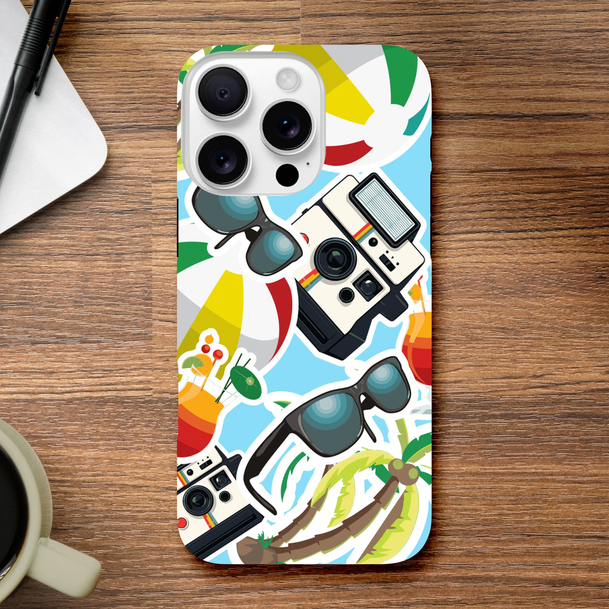 Blue summer sticker effect iPhone case featuring palm trees, retro cameras, sunglasses, and beach balls on a vibrant background.