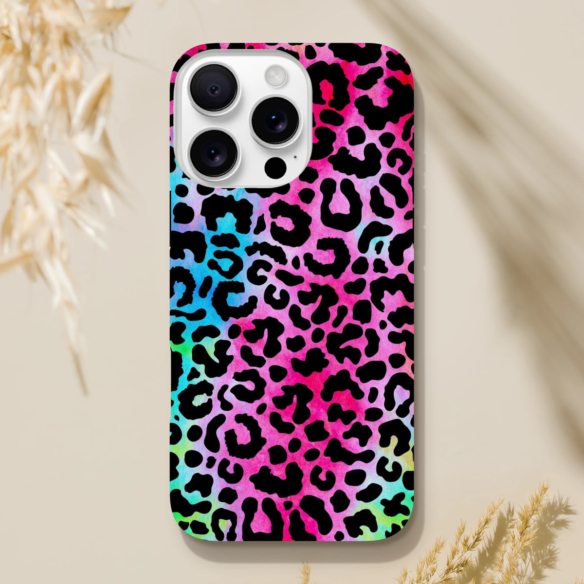Vibrant rainbow leopard print tough iPhone case providing drop protection and bold animal print style with full wireless charging access.