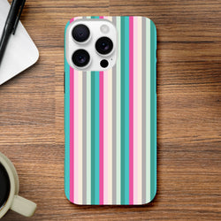 Retro pink and aqua vertical stripe tough iPhone case on wooden desk with coffee and pen.