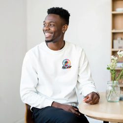 Man wearing white full send urban palm trees sweatshirt featuring colorful tropical graphic on chest.