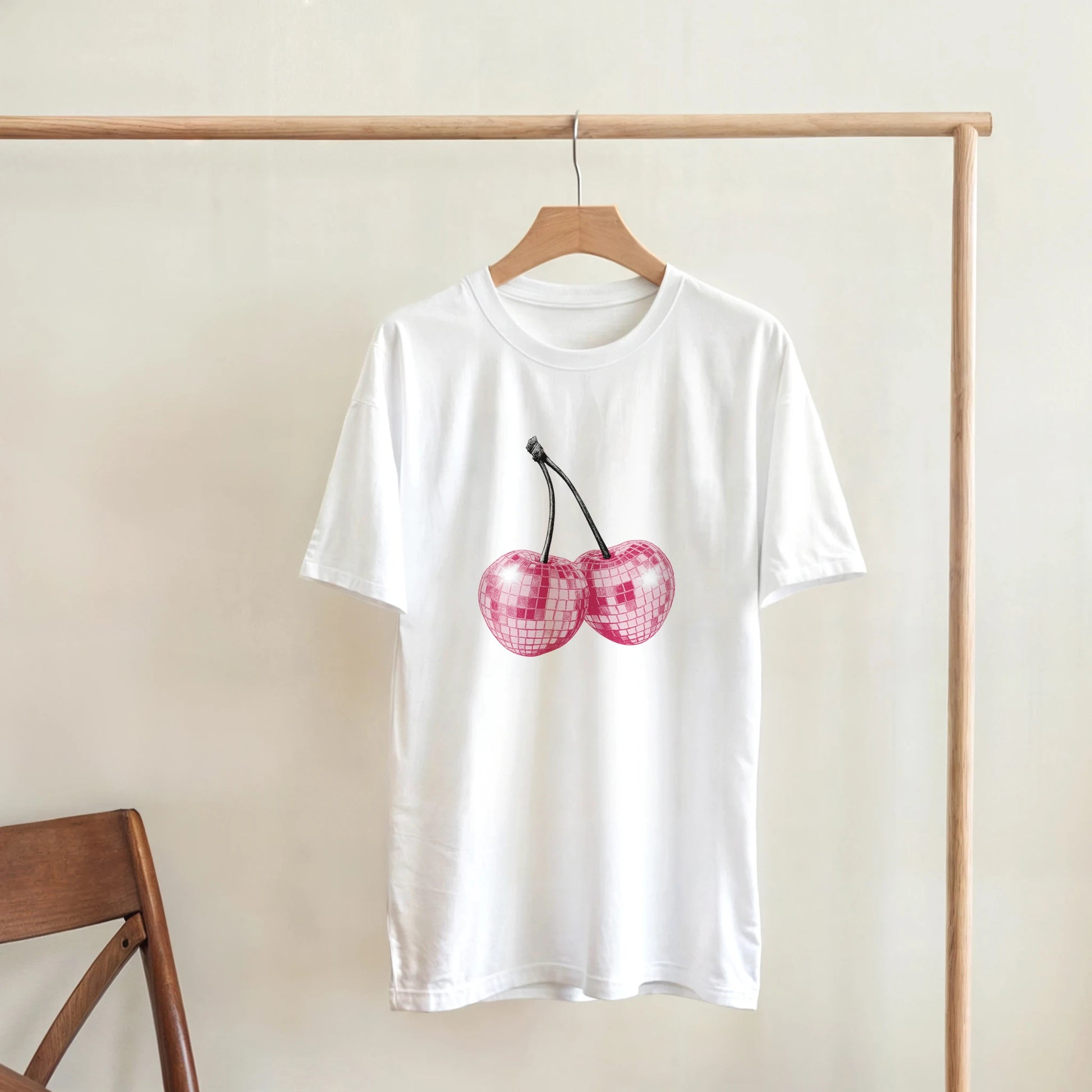 Glitter Ball Cherries T-shirt on white cotton with pink cherry graphic, relaxed fit.