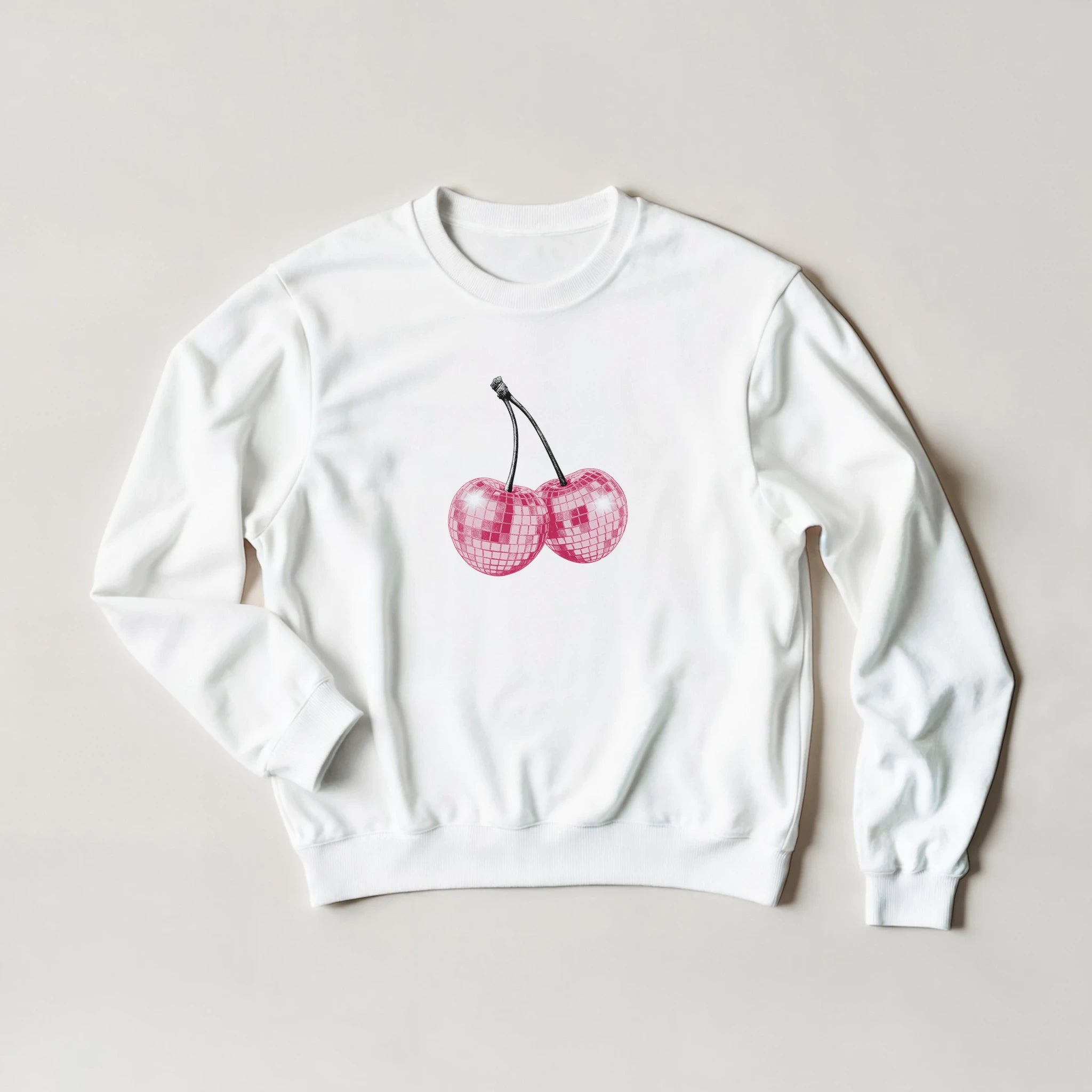 White crewneck sweatshirt featuring pink glittery cherry graphic in a pastel Y2K-inspired style.