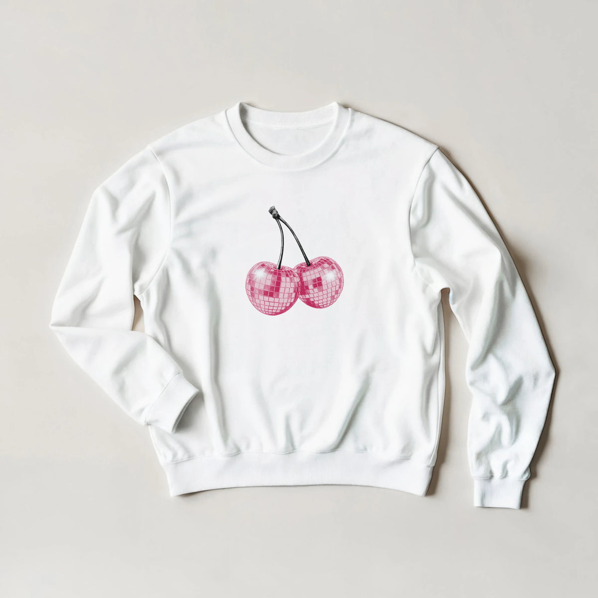 White crewneck sweatshirt featuring pink glittery cherry graphic in a pastel Y2K-inspired style.