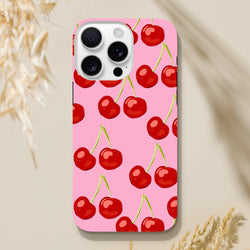Pink iPhone case featuring a vibrant red cherry pattern on a soft pink background, designed for street-ready style.