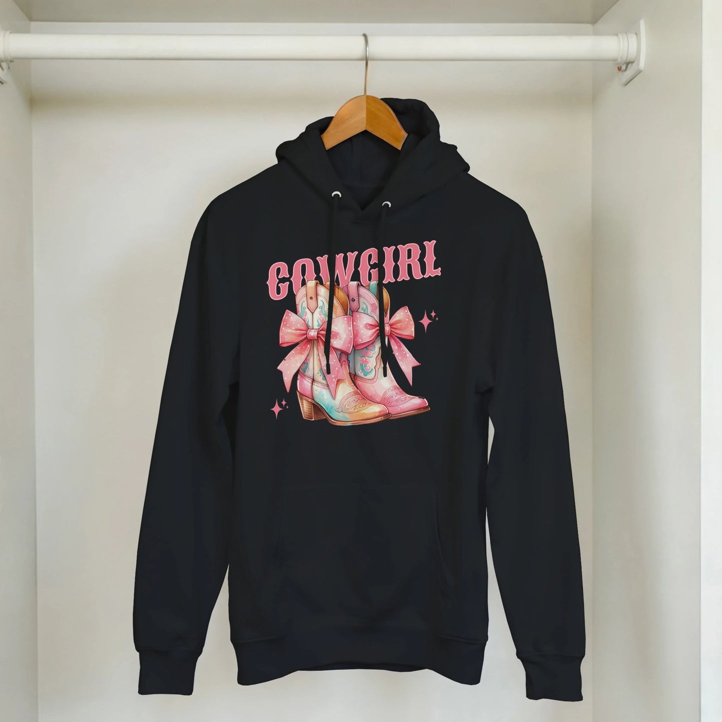 Black hoodie with pastel cowgirl boots graphic and pink COWGIRL text, front pouch pocket, drawstring hood.