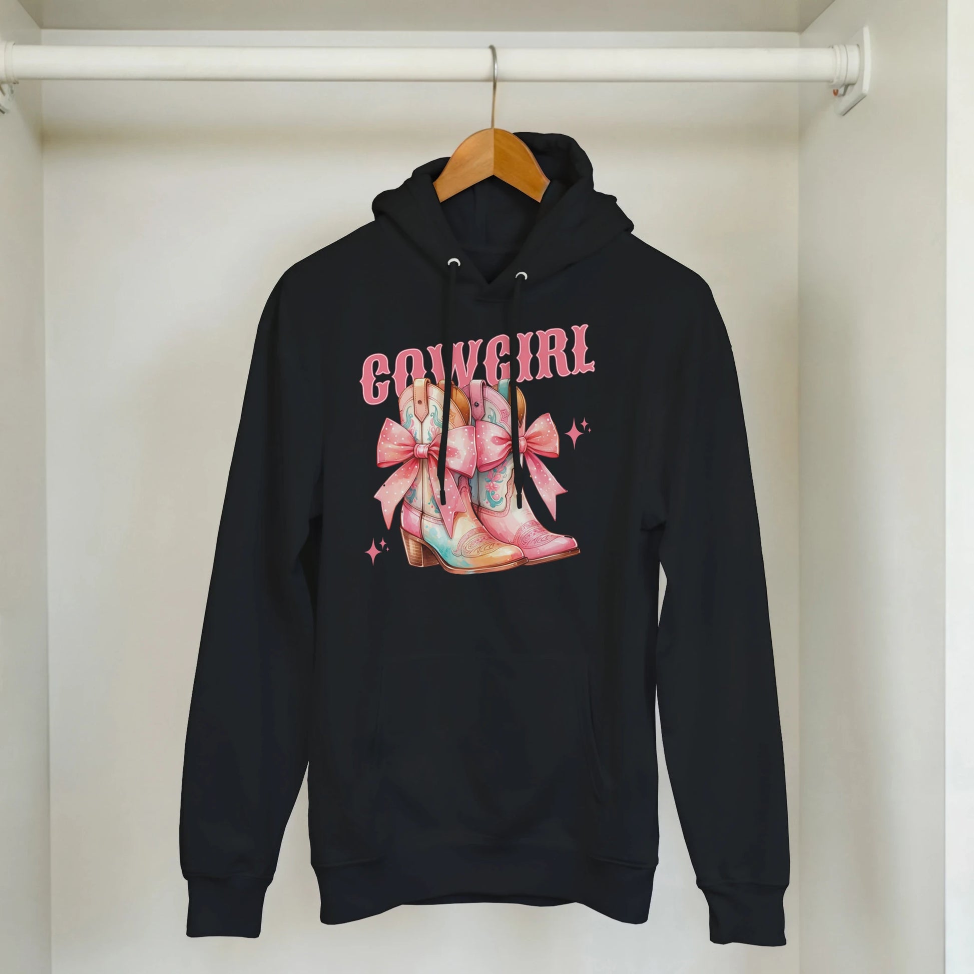 Black hoodie with pastel cowgirl boots graphic and pink COWGIRL text, front pouch pocket, drawstring hood.