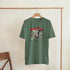Gothic guardian angel graphic T-shirt in olive green, red text, short-sleeve crew neck, on hanger.