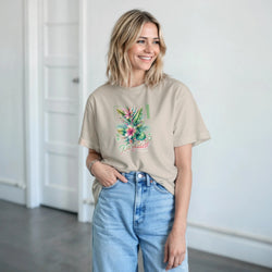 Beige Paradise women's graphic T-shirt with tropical floral print worn by a smiling model.